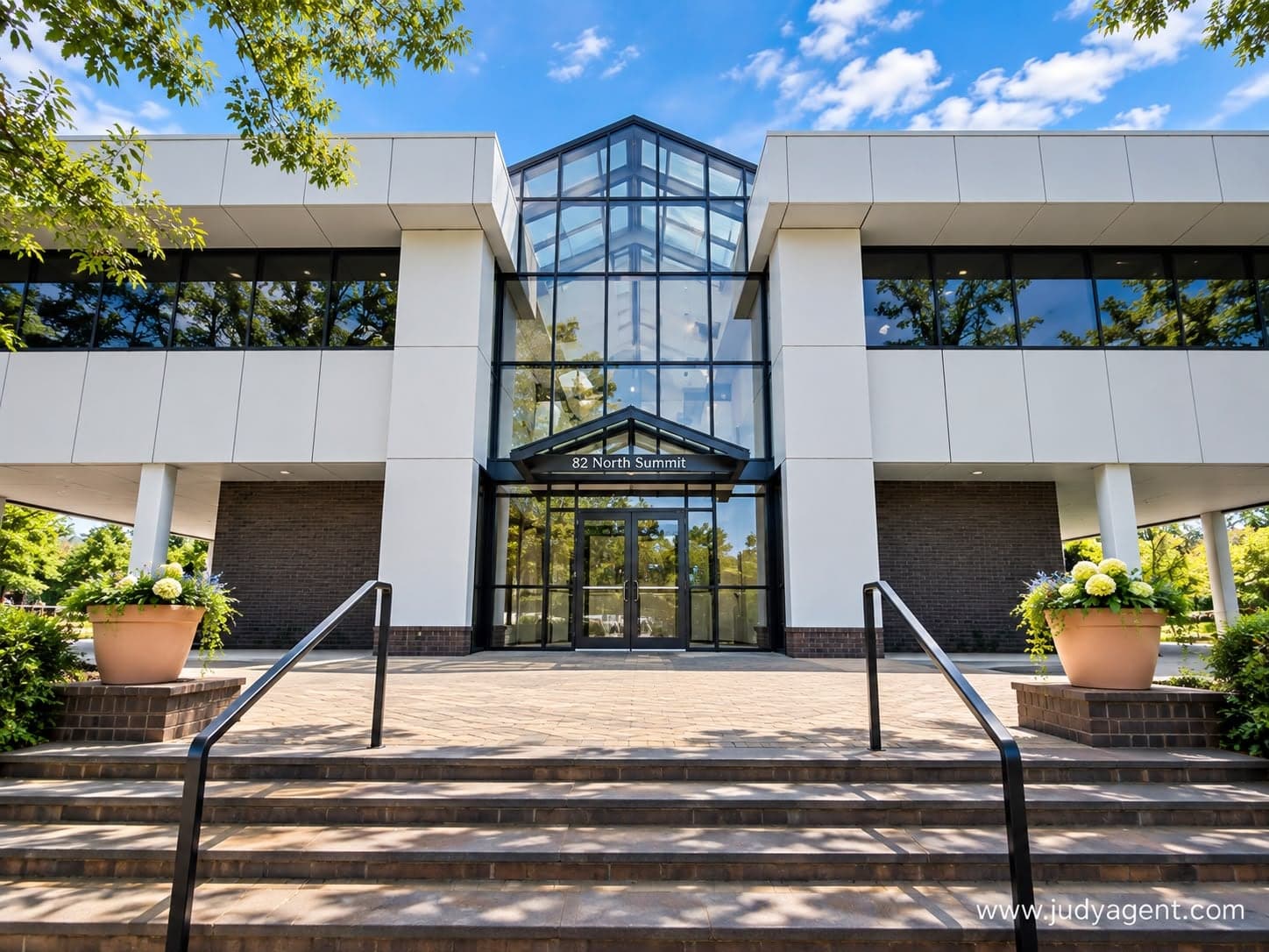 Entrance of the Keller Williams Town Life office at 82 North Summit Street, Tenafly, with a glass atrium above the doors